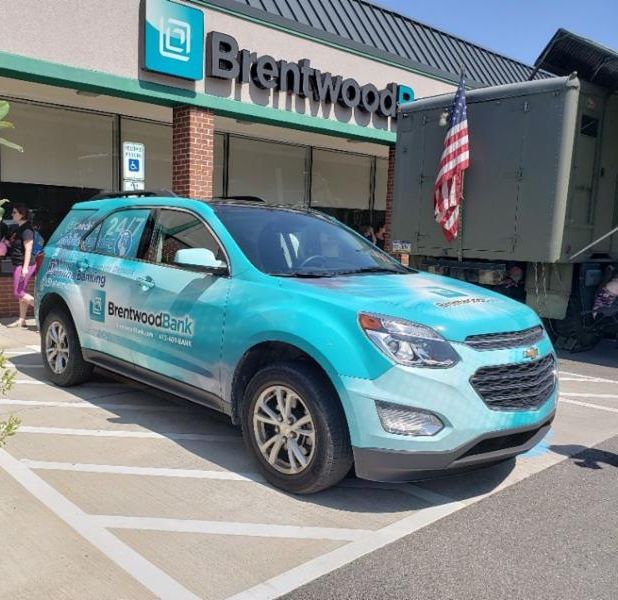 Brentwood Bank car parked in front of South Park Shops branch office.