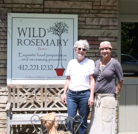 Owners of Wild Rosemary restaurant standing in front of their restaurant.