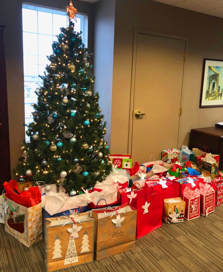 Christmas tree surrounded by presents at City Mission.