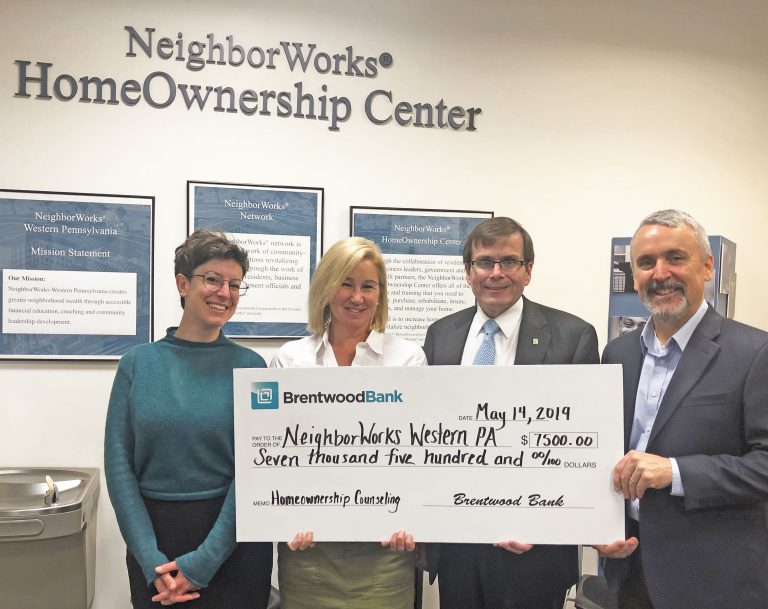 Tom Bailey and Carrie Havas of Brentwood Bank presenting a check to Neighborworks.