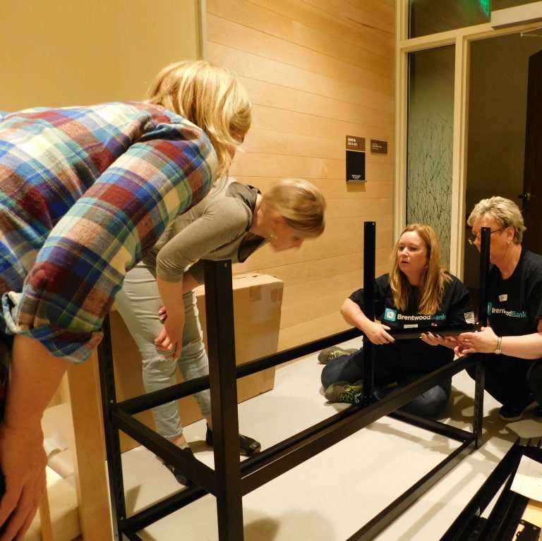 Brentwood Bank volunteers building a table at Women's Center and Shelter of Pittsburgh.