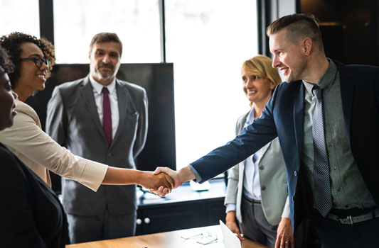 Business owners and bankers shaking hands on completion of a business loan