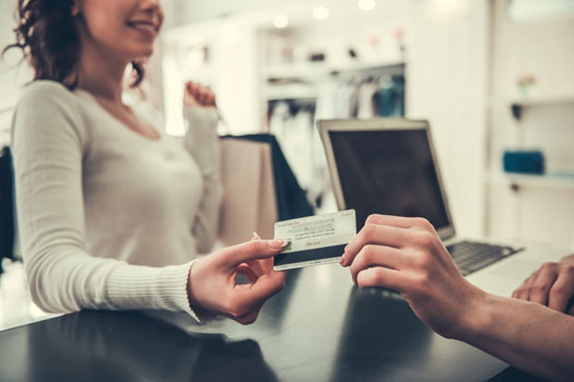 Business owner accepting credit card payment from customer