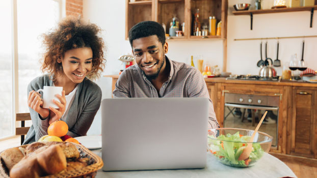 Young couple searching online for a simple checking account